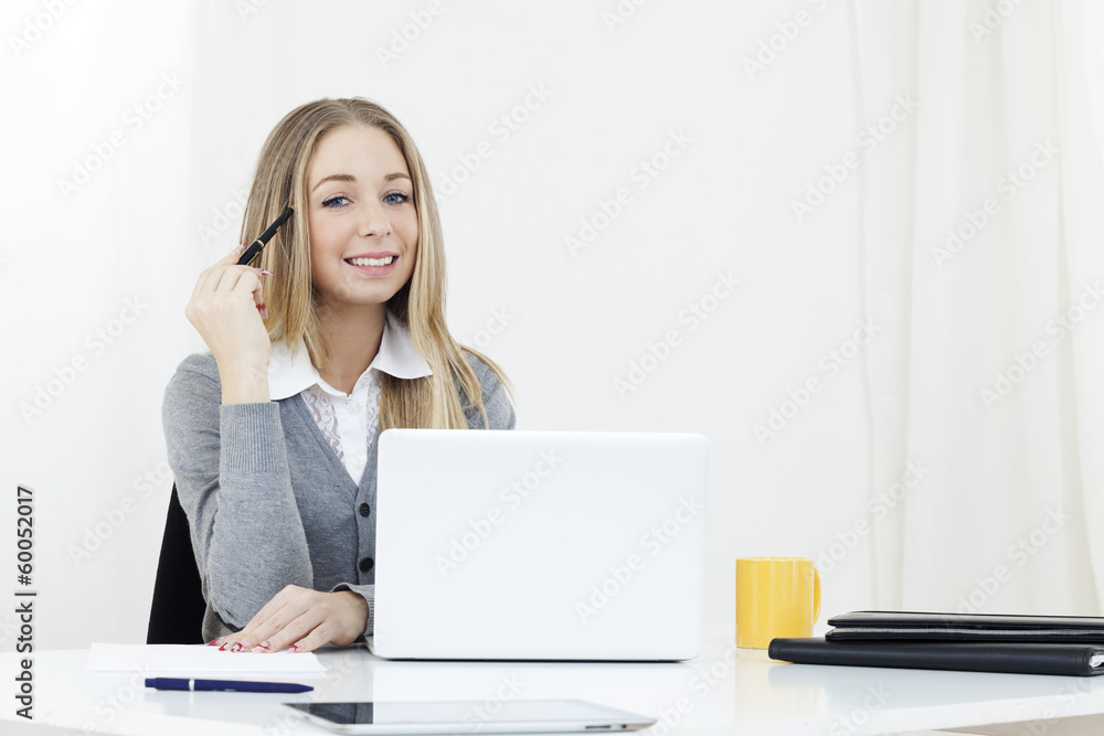 Business woman sitting at a desk office computer Business woman sitting at a desk office computer
