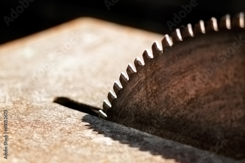 A close-up picture of a rusty circular saw in an old sawmill