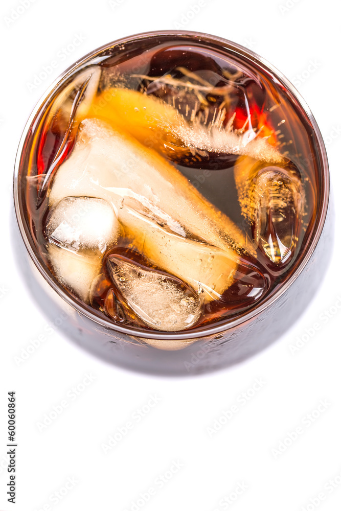 Cola drink with ice cubes in a short glass over white background Cola drink with ice cubes in a short glass over white background