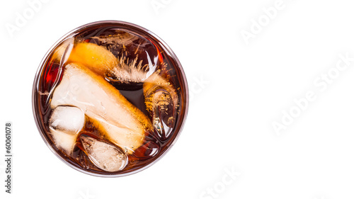 Cola drink with ice cubes in a short glass over white background