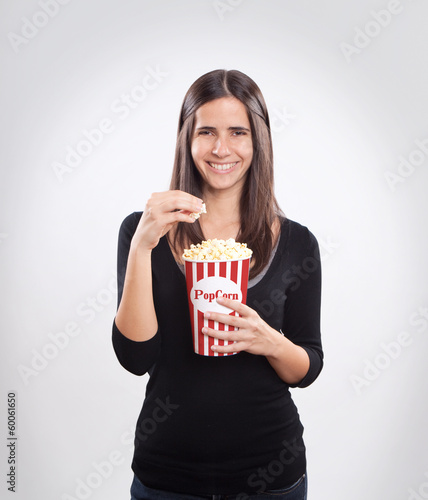 Young happy woman eating popcorn