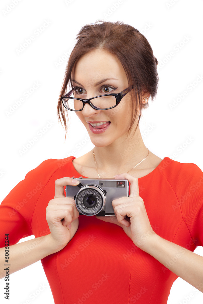 Girl in a red dress with shiny camera on a white background Girl in a red dress with shiny camera on a white background