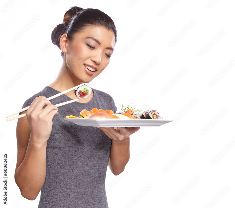 Woman holding sushi with chopsticks looking at the camera smilin Woman holding sushi with chopsticks looking at the camera smilin