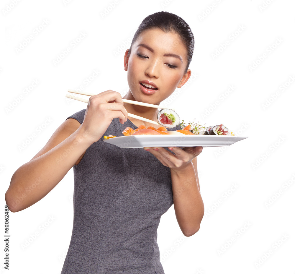 Woman holding sushi with chopsticks looking at the camera smilin Woman holding sushi with chopsticks looking at the camera smilin