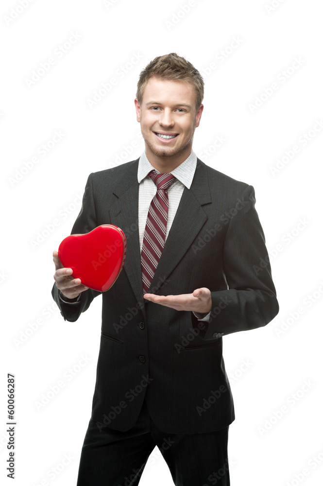 young cheerful businessman holding red heart young cheerful businessman holding red heart