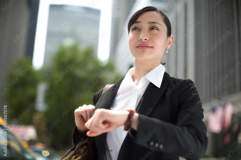 Asian business woman in New York City checking time Asian business woman in New York City checking time