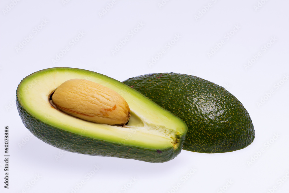 half avocado with stone isolated on white background half avocado with stone isolated on white background