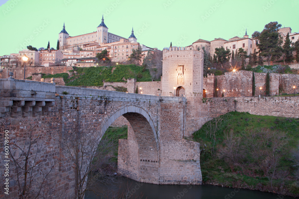 Toledo - Alcazar and Punte de Alcantara bridge in morning dusk