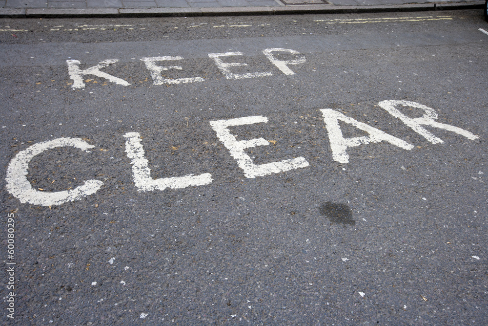 Fototapeta premium Close-Up of road marking saying Keep Clear in London, UK