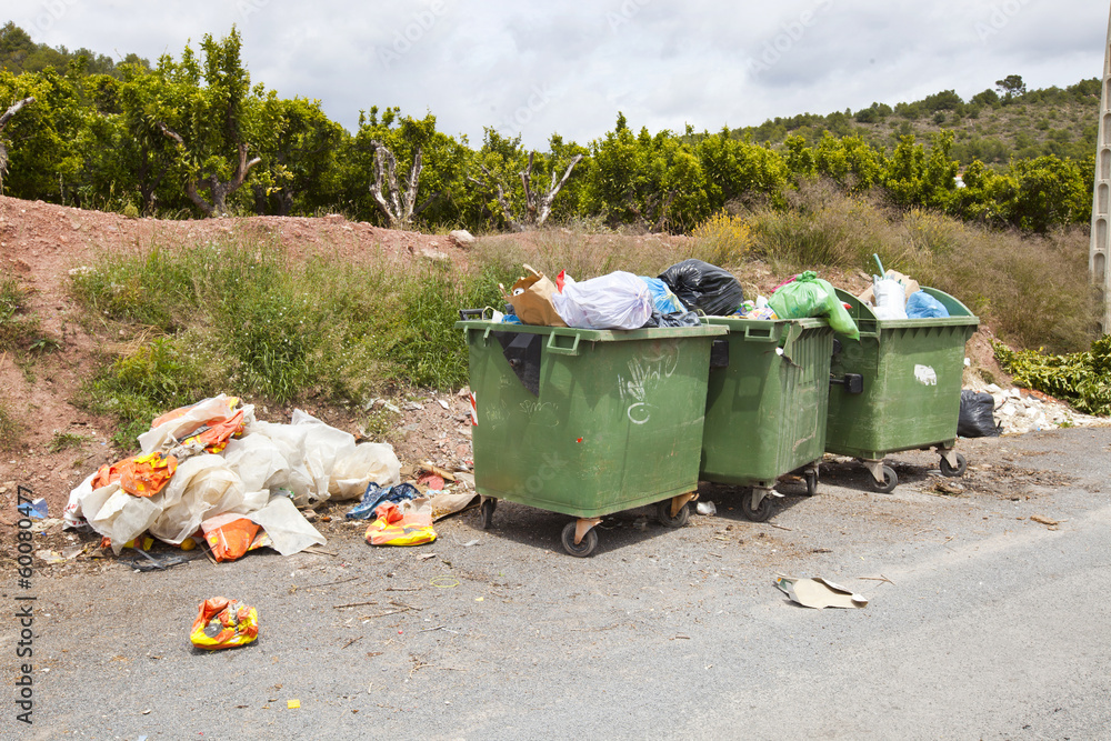 Overflowing bins next to Orange Orchard, Valencia region, Spain Overflowing bins next to Orange Orchard, Valencia region, Spain