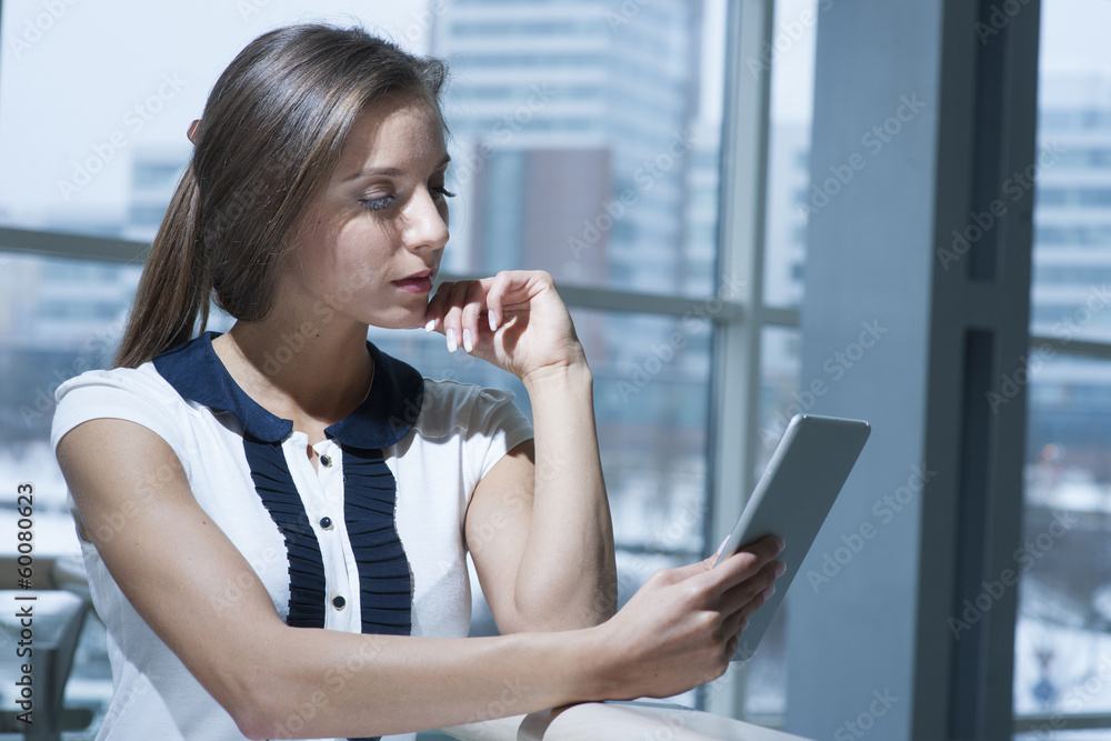 Pensive businesswoman reading from digital tablet Pensive businesswoman reading from digital tablet