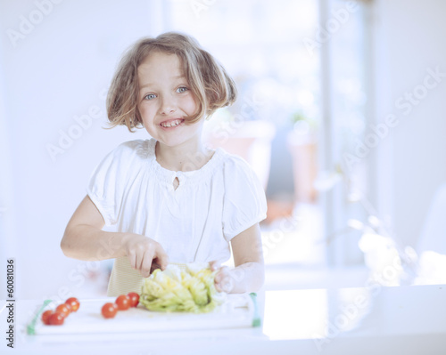 Young girl making a salad
