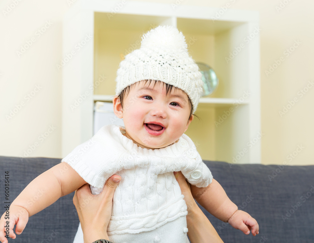 Asian baby girl embraced by parent Asian baby girl embraced by parent