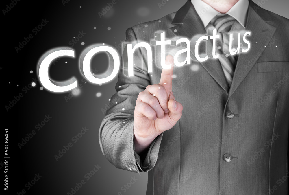 Businessman pushing CONTACT US sign Businessman pushing CONTACT US sign