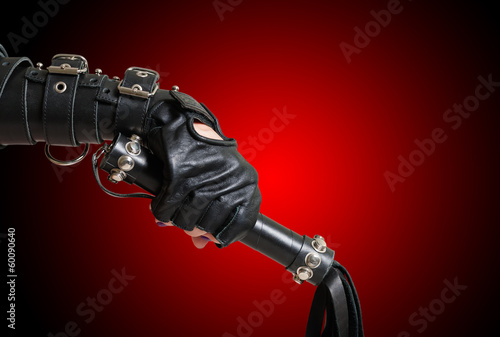 Fist in leather glove with lash