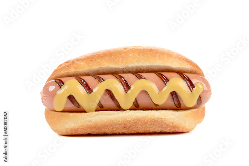 Hand hold hotdog with mustard.