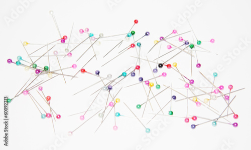 Safety pins with colored circular heads for sewing on white