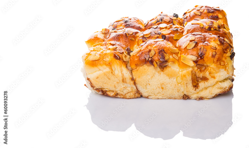 Homemade sweet bun with almond and raisins on a white background Homemade sweet bun with almond and raisins on a white background