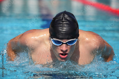 Close up of swimmer  Man swimming butterfly strokes