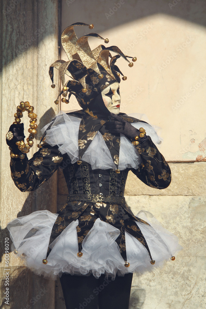 Fototapeta premium Dark elegant joker posing in San Marco square