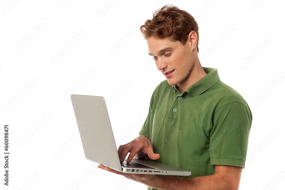 Handsome guy operating laptop Handsome guy operating laptop