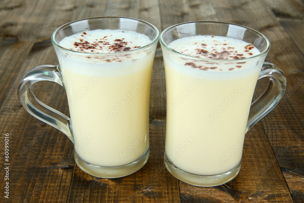 Cups of eggnog on wooden background Cups of eggnog on wooden background