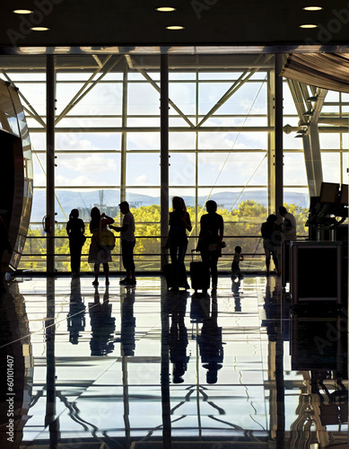 Silhouettes of unrecognizable traveling people at the airport