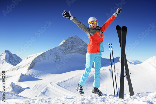 Jumping girl in fresh snow powder - winter fun
