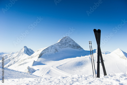 Skis in high mountains at sunny day