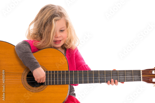 little girl is oplaying with the guitar
