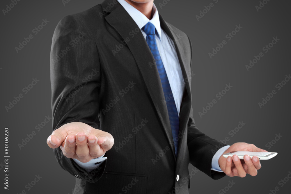 businessman holding mobile smart phone, another hand presenting