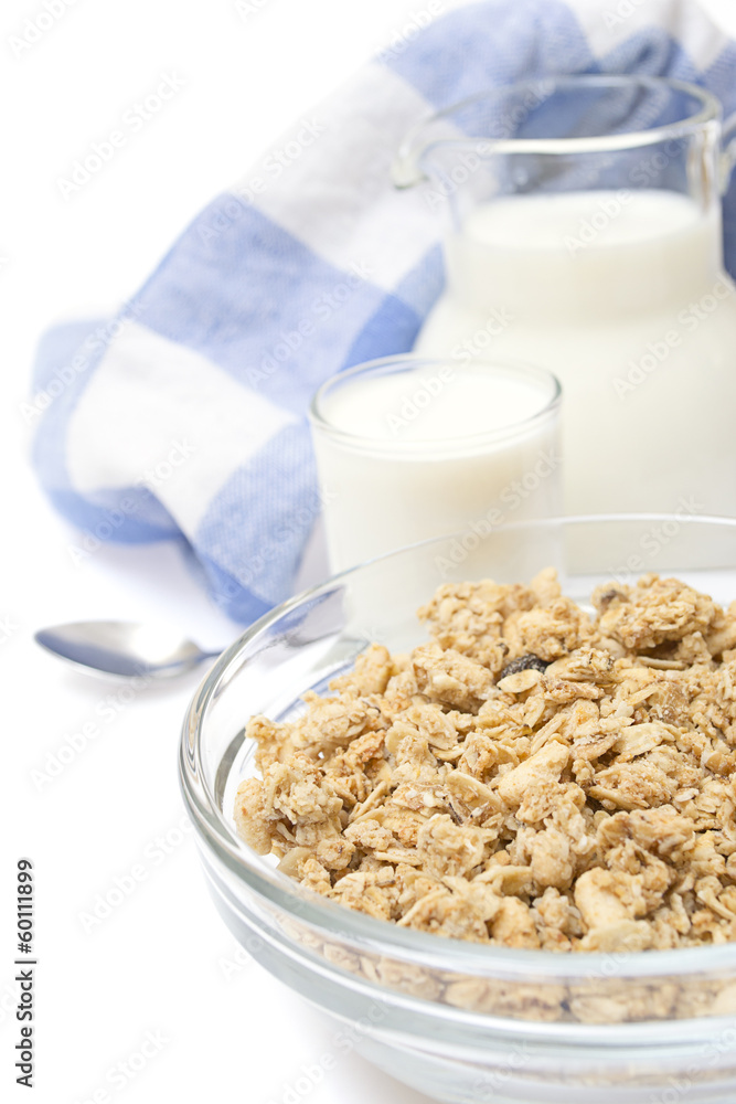 Close-up of a bowl of cereal with a jug of fresh milk, isolated Close-up of a bowl of cereal with a jug of fresh milk, isolated