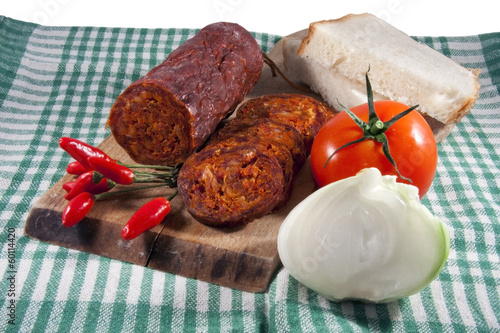 Hungarian homemade paprika salami with vegetables photo