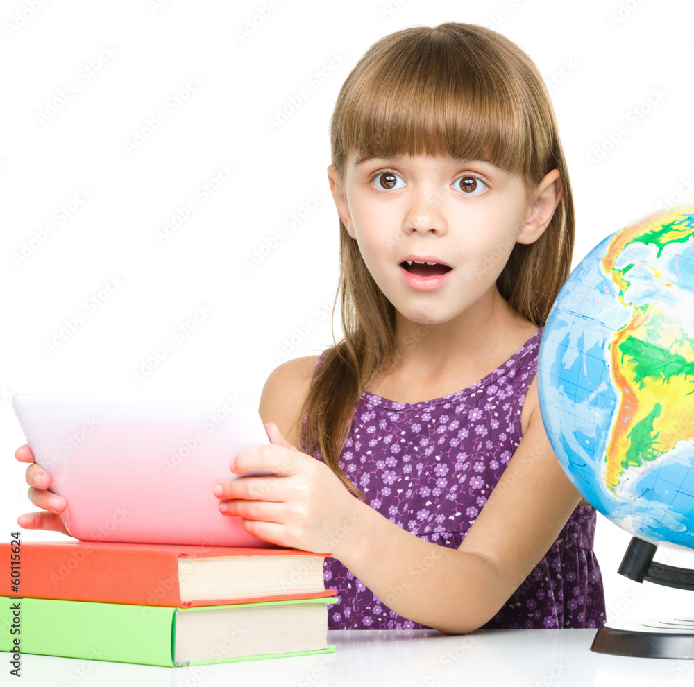 Young girl is using tablet while studying Young girl is using tablet while studying