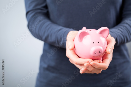 Care for Savings - Woman with a Piggy Bank