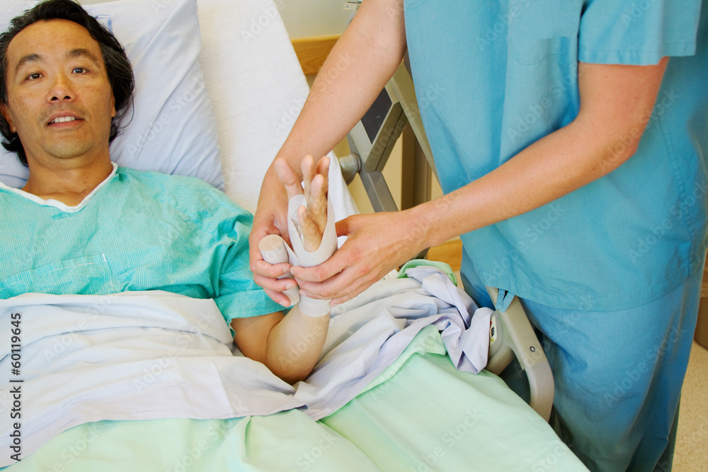 Nurse wrapping tensor to patients arm Nurse wrapping tensor to patients arm