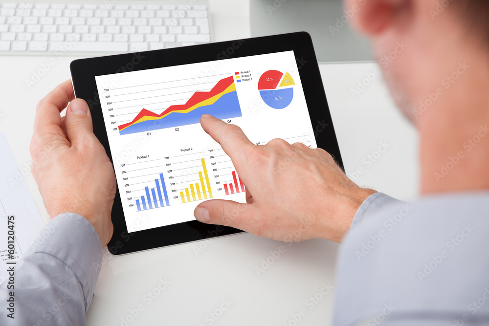 Businessman Analyzing Graph On Digital Tablet Businessman Analyzing Graph On Digital Tablet