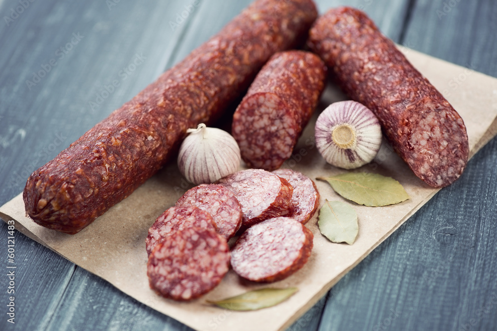 Salami, garlic and bay leaves, horizontal shot Salami, garlic and bay leaves, horizontal shot