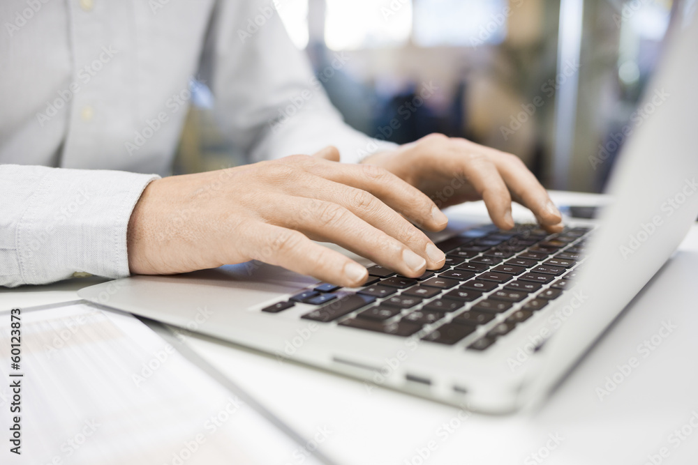 Man Typing on a keyboard laptop in an office, e-mail, message Man Typing on a keyboard laptop in an office, e-mail, message