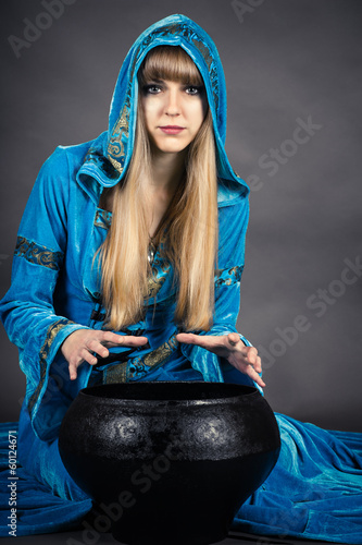 Photo witch with cauldron isolated on gray background