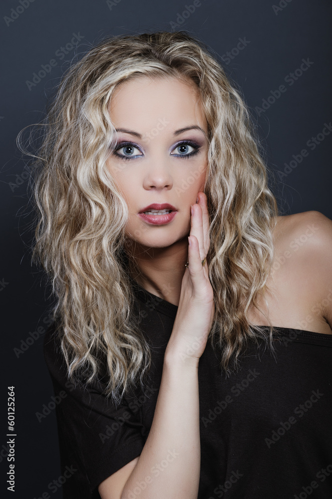 Young, beautiful girl in a professional make-up and hairdo in bl Young, beautiful girl in a professional make-up and hairdo in bl