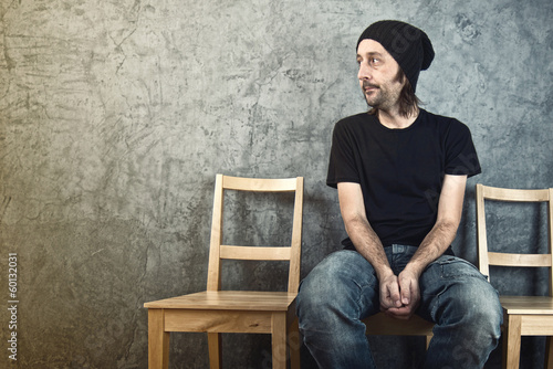 Принти на полотні Man sitting on wooden chair and waiting