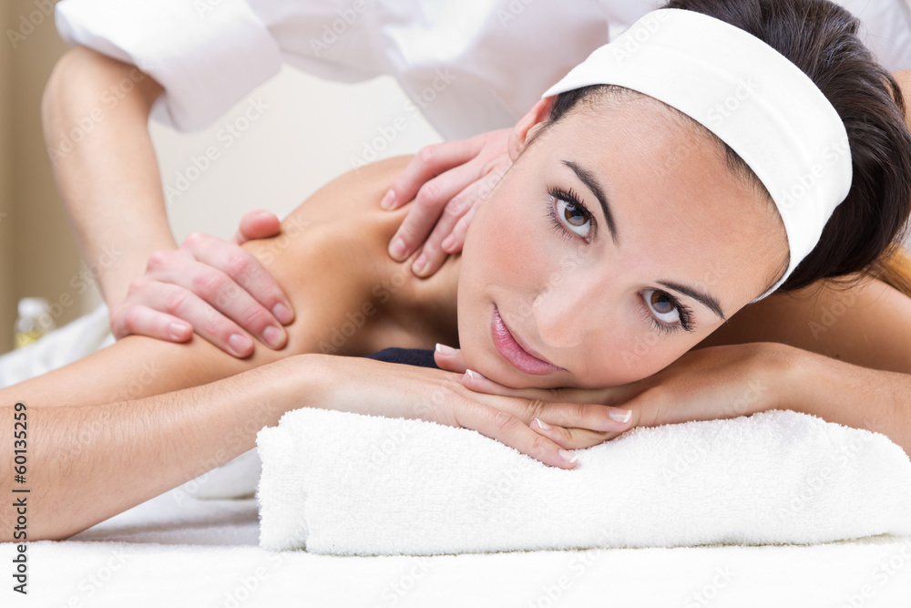Woman enjoying shoulder massage at beauty spa Woman enjoying shoulder massage at beauty spa
