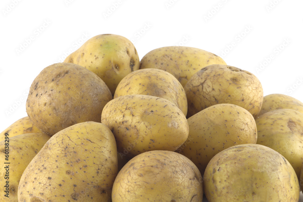 Heap of many ripe brown potatoes isolated close up