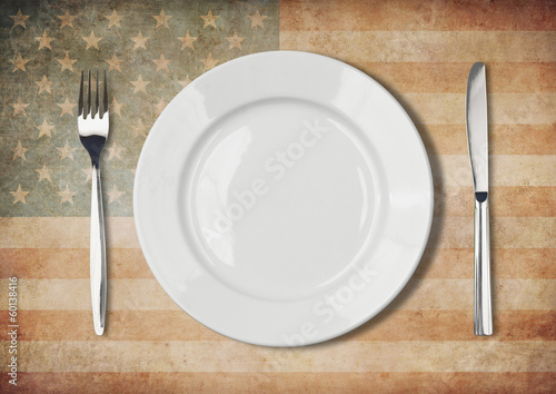 Plate, fork and knife on old USA flag