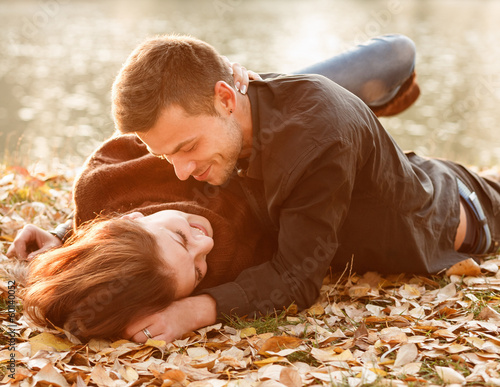 young couple lying down smiling