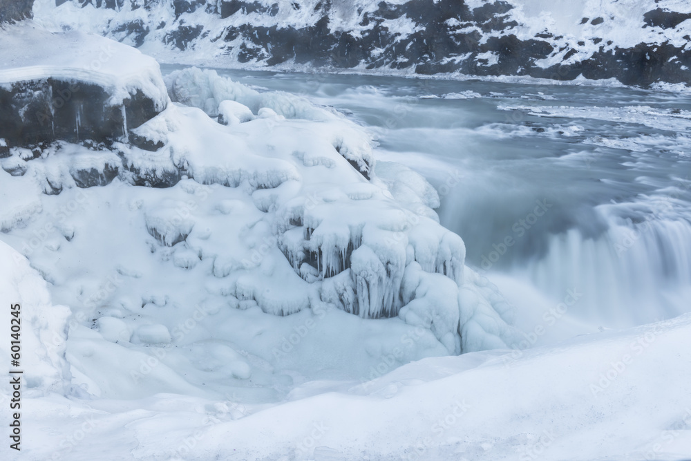Partially frozen waterfall Gulfoss, Iceland in wintertime Partially frozen waterfall Gulfoss, Iceland in wintertime