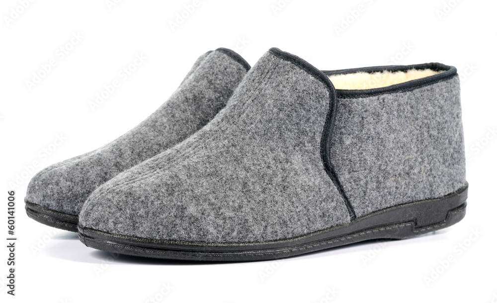 Pair of men's grey slippers on white background. Pair of men's grey slippers on white background.