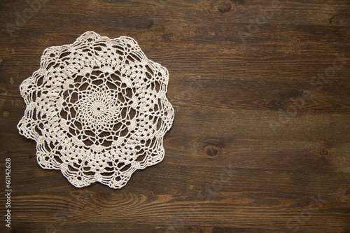 Crochet doily overdark  wood photo