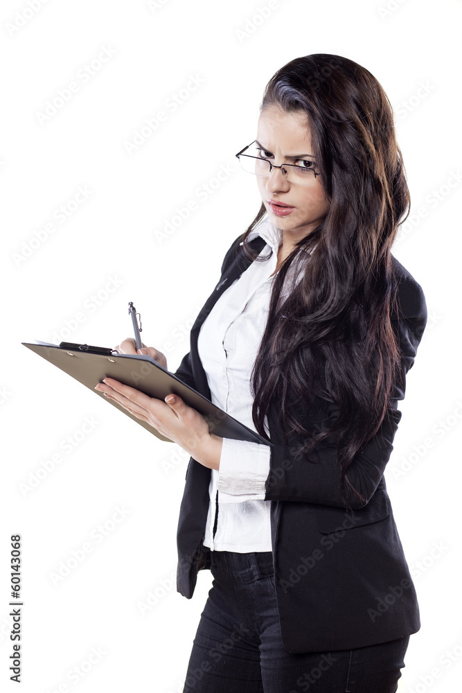 young serious business woman writing on her clipboard young serious business woman writing on her clipboard